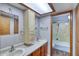 Clean bathroom featuring a double sink vanity, a shower, and neutral colors creating a serene atmosphere at 2424 E Ivy St, Mesa, AZ 85213