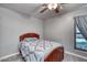 Comfortable bedroom with neutral decor, cozy bed, and a window offering natural light at 2424 E Ivy St, Mesa, AZ 85213