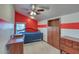 A bedroom showcasing a bed, natural light and red and white accent walls that create a unique look at 2424 E Ivy St, Mesa, AZ 85213