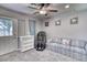 Relaxing bedroom featuring a comfortable sofa, a dresser, and an exit door, creating a calming retreat at 2424 E Ivy St, Mesa, AZ 85213