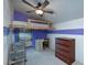 Bedroom featuring a loft bed and desk area, perfect for work and rest, accentuated by colorful accent walls at 2424 E Ivy St, Mesa, AZ 85213