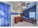 A cozy bedroom featuring blue accent walls and a wooden dresser adding warmth to the space at 2424 E Ivy St, Mesa, AZ 85213