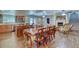 Open-concept dining area featuring a large table, wood floors, and seamlessly flowing into the kitchen and living spaces at 2424 E Ivy St, Mesa, AZ 85213