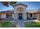 Inviting entryway with stone accents, tiled roof, table and chairs offering curb appeal and a cozy feel at 2424 E Ivy St, Mesa, AZ 85213