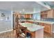 Bright kitchen with stainless steel appliances, center island, plenty of cabinet space and barstool seating at 2424 E Ivy St, Mesa, AZ 85213