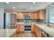 Well-lit kitchen featuring stainless appliances, wood cabinets, and granite countertops offering lots of space at 2424 E Ivy St, Mesa, AZ 85213