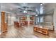 Expansive living area featuring wood-look flooring, brick fireplace, ample seating and lots of natural light at 2424 E Ivy St, Mesa, AZ 85213