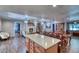 Spacious living area boasts wood-look floors, a brick fireplace, and an open layout connecting kitchen and seating at 2424 E Ivy St, Mesa, AZ 85213