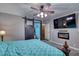 Cozy main bedroom features a comfortable bed, a TV, and modern decorative touches at 2424 E Ivy St, Mesa, AZ 85213