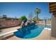 Pool featuring a rock waterfall slide, surrounded by desert landscaping, perfect for Gathering fun at 2424 E Ivy St, Mesa, AZ 85213