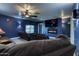 A theater room with a large-screen TV and cozy seating for a relaxed viewing experience at 2424 E Ivy St, Mesa, AZ 85213