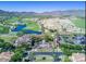 Aerial view of the golf course and community highlighting the lush landscaping and beautiful desert surroundings at 2701 N Black Rock Rd, Buckeye, AZ 85396
