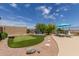 Backyard features a putting green, seating area, mature landscaping, and desert views at 2701 N Black Rock Rd, Buckeye, AZ 85396