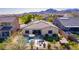 Beautiful aerial view of backyard oasis with pool, putting green, and hot tub, perfect for outdoor living at 2701 N Black Rock Rd, Buckeye, AZ 85396