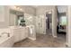 Elegant bathroom with soaking tub, glass shower, and walk-in closet at 2701 N Black Rock Rd, Buckeye, AZ 85396