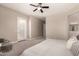 Spacious bedroom with neutral walls, carpet, ceiling fan, patio access, and en suite bathroom at 2701 N Black Rock Rd, Buckeye, AZ 85396