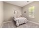 Comfortable bedroom boasts plush carpeting and natural light from a bright window at 2701 N Black Rock Rd, Buckeye, AZ 85396