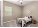 Relaxing bedroom features a large window, plush carpeting, and neutral walls at 2701 N Black Rock Rd, Buckeye, AZ 85396