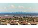 City skyline view overlooking residential neighborhood, desert landscape and clear sky at 2701 N Black Rock Rd, Buckeye, AZ 85396