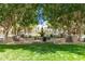 Community park with fountain, mature trees, benches and manicured lawn at 2701 N Black Rock Rd, Buckeye, AZ 85396