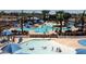 Community pool area with multiple pools, lounge chairs, umbrellas, and palm trees at 2701 N Black Rock Rd, Buckeye, AZ 85396