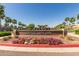 Community sign reading 'Heritage Swim Park' amid palm trees and landscaping under a clear blue sky at 2701 N Black Rock Rd, Buckeye, AZ 85396