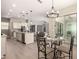 Open floor plan of kitchen, dining nook, and living room with access to covered patio through sliding glass door at 2701 N Black Rock Rd, Buckeye, AZ 85396