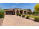 Stunning property featuring a stone driveway, manicured lawn, and beautiful landscaping enhancing its curb appeal at 2701 N Black Rock Rd, Buckeye, AZ 85396