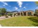 Attractive home with a well-manicured lawn, mature landscaping, and a paver driveway leading to the garage at 2701 N Black Rock Rd, Buckeye, AZ 85396