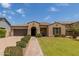 Charming home featuring a tile roof, well-maintained landscaping, and a paver walkway leading to the front door at 2701 N Black Rock Rd, Buckeye, AZ 85396