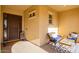 Inviting front porch with cozy seating, a decorative rug, and a charming welcome sign at 2701 N Black Rock Rd, Buckeye, AZ 85396