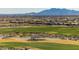 Picturesque golf course with desert landscaping, lush greens, and panoramic mountain views in the background at 2701 N Black Rock Rd, Buckeye, AZ 85396