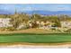 Well-maintained golf green featuring a flag, surrounded by desert vegetation and a mountain vista at 2701 N Black Rock Rd, Buckeye, AZ 85396