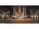 Festive holiday decorations light up the property with dazzling displays of lights and towering Christmas trees at 2701 N Black Rock Rd, Buckeye, AZ 85396