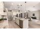 Open-concept kitchen with stainless steel appliances, granite counters, island with sink, and adjacent living area at 2701 N Black Rock Rd, Buckeye, AZ 85396