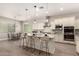 Open-concept kitchen features a large center island, stainless steel appliances, and breakfast bar at 2701 N Black Rock Rd, Buckeye, AZ 85396