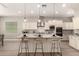Modern kitchen features a large island, stainless steel appliances, and breakfast bar at 2701 N Black Rock Rd, Buckeye, AZ 85396
