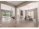 Open-concept living area with views of the dining room, pool, and outdoor space at 2701 N Black Rock Rd, Buckeye, AZ 85396