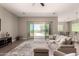 Cozy living room with neutral tones, wood-look floors, and seamless access to a backyard pool and patio area at 2701 N Black Rock Rd, Buckeye, AZ 85396