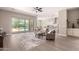 Bright living room boasts wood-look floors, open to kitchen, and sliding glass doors leading to the backyard pool at 2701 N Black Rock Rd, Buckeye, AZ 85396