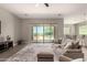Comfortable living room with view of the pool and patio through sliding glass doors for seamless indoor-outdoor living at 2701 N Black Rock Rd, Buckeye, AZ 85396