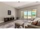 Inviting living room featuring wood-look floors, seamless access to a backyard oasis, and a cozy seating area at 2701 N Black Rock Rd, Buckeye, AZ 85396