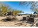 Open-air patio featuring comfortable seating, a stone fountain, and lush landscaping with mountain views at 2701 N Black Rock Rd, Buckeye, AZ 85396