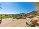 Expansive patio area with comfortable seating, lush greenery, and scenic mountain views at 2701 N Black Rock Rd, Buckeye, AZ 85396