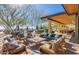 Inviting outdoor seating area with comfortable chairs, desert landscaping, and views of distant mountains at 2701 N Black Rock Rd, Buckeye, AZ 85396