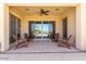 Covered patio area with ceiling fan and an outdoor dining area overlooking mountain views at 2701 N Black Rock Rd, Buckeye, AZ 85396