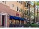 Exterior of Grazie Pizzeria with blue awning and outdoor seating at 2701 N Black Rock Rd, Buckeye, AZ 85396