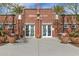 Community pool house with brick facade and glass entry doors under a clear sky with manicured landscaping at 2701 N Black Rock Rd, Buckeye, AZ 85396