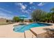 Gorgeous pool with desert views, privacy fence, tanning ledge, and lush landscaping at 2701 N Black Rock Rd, Buckeye, AZ 85396