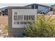 The Cliff House sign, a modern building, green bushes, and a couple of cars are visible in the background at 2701 N Black Rock Rd, Buckeye, AZ 85396